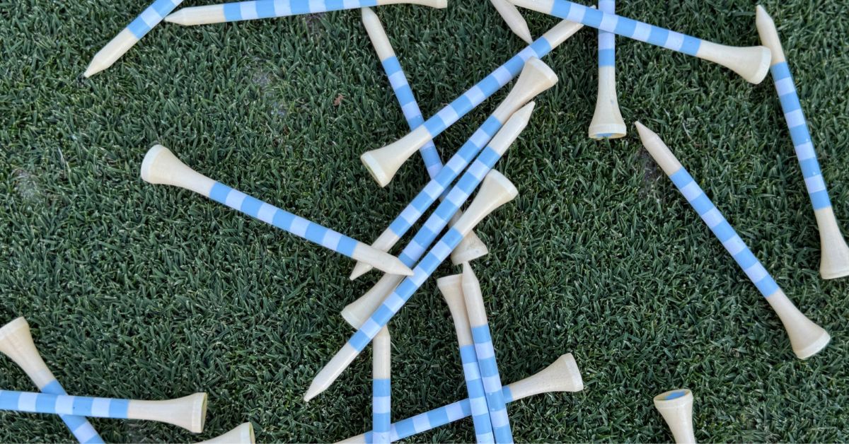 Striped Wood Golf Tees laid out on the golf green