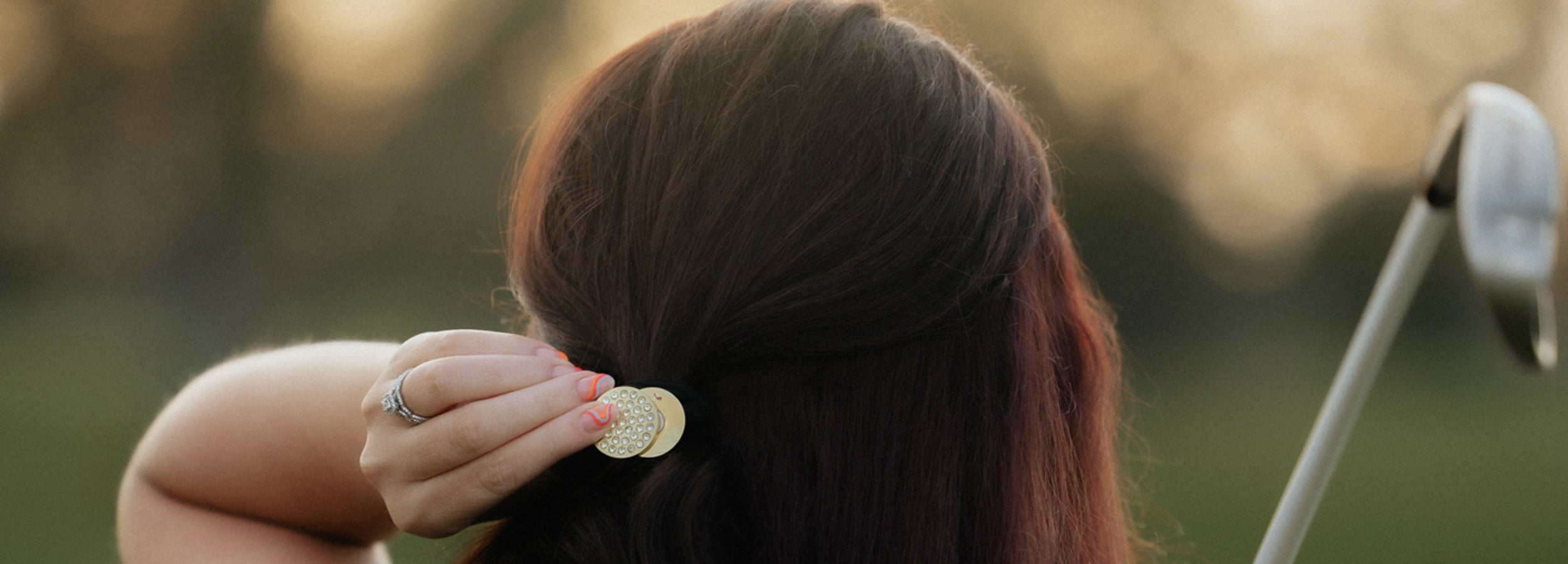 Woman golfer with Birdie Girl magnetic ball marker hair tie 