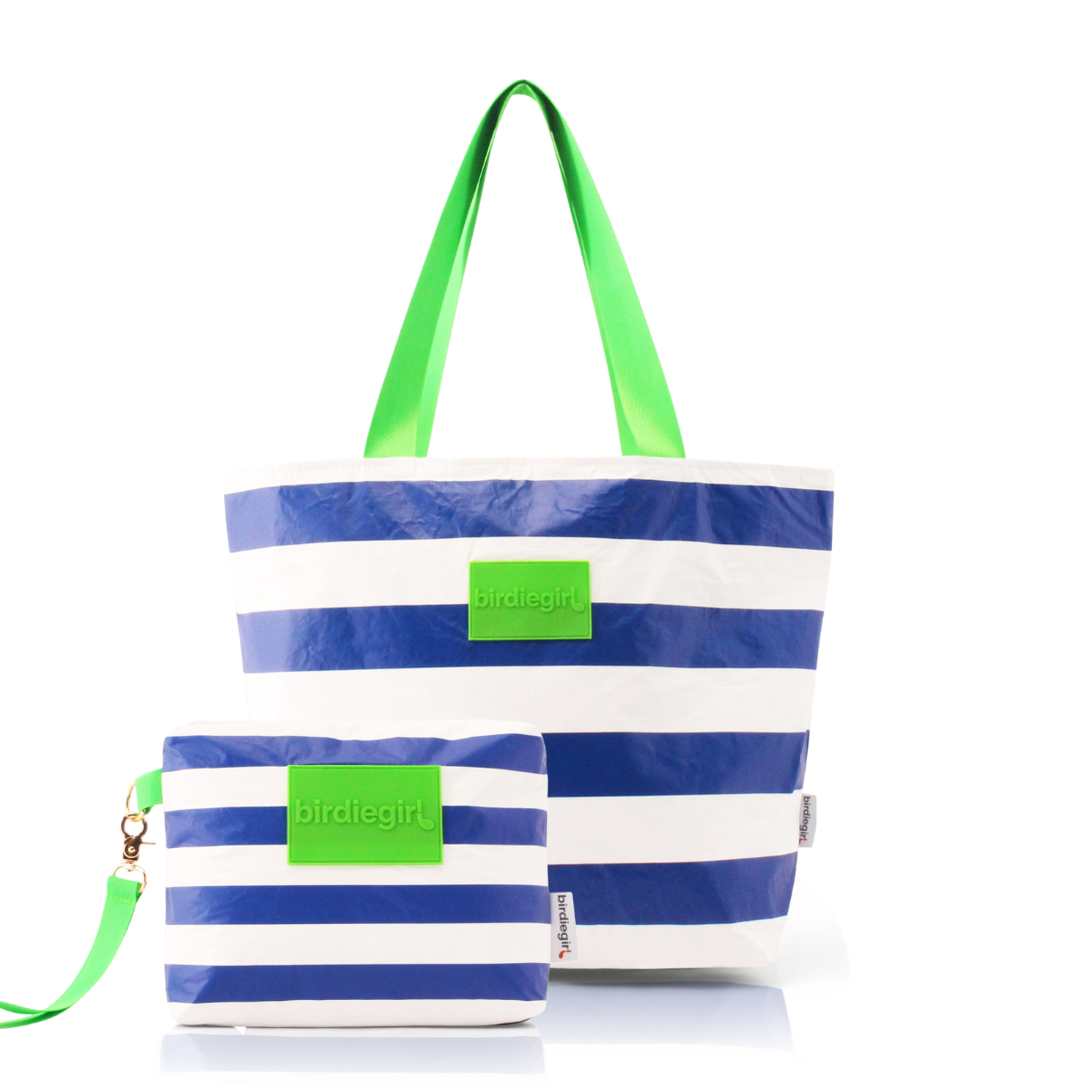 Navy and white striped golf tote bag with green handles on a cart seat